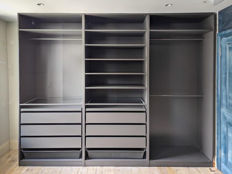 IKEA PAX wardrobe — three-bay configuration with drawers and rails