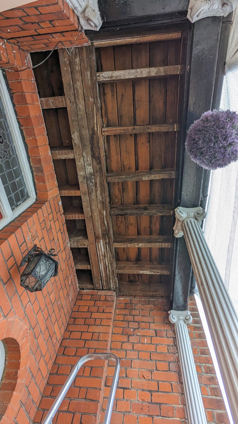 Victorian porch ceiling before — bare dark timber, weathered