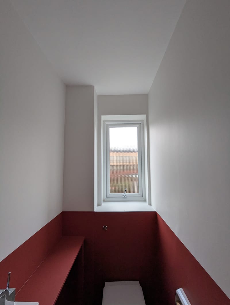 Downstairs WC after — terracotta dado paint, perfect cut-line, white above