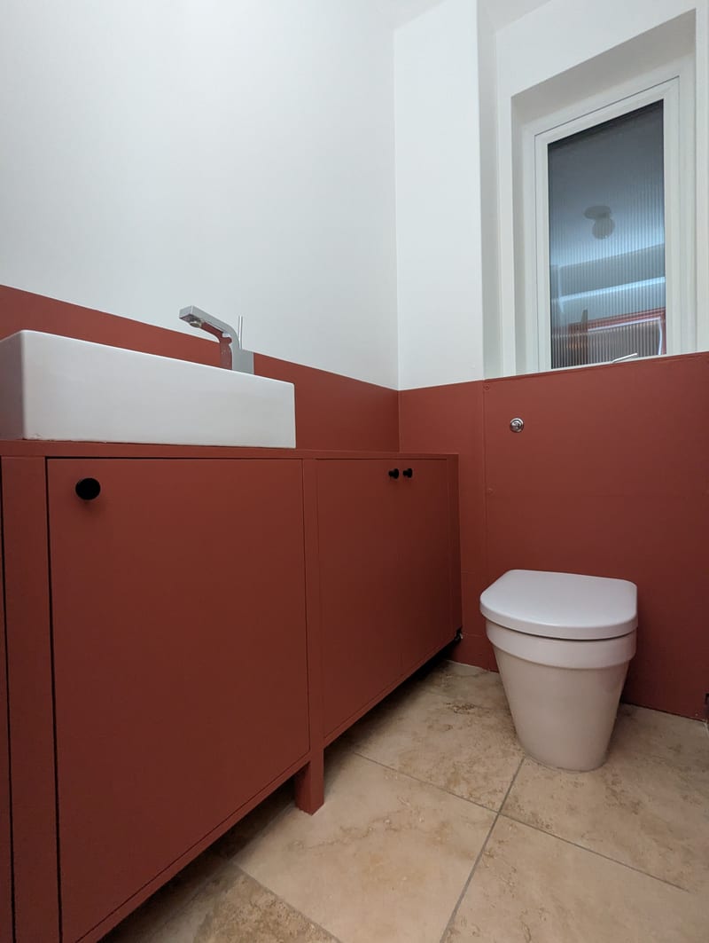 Downstairs WC after — fitted vanity unit in matching terracotta