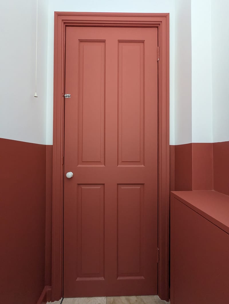 Downstairs WC after — close-up of cabinet doors and chrome tap